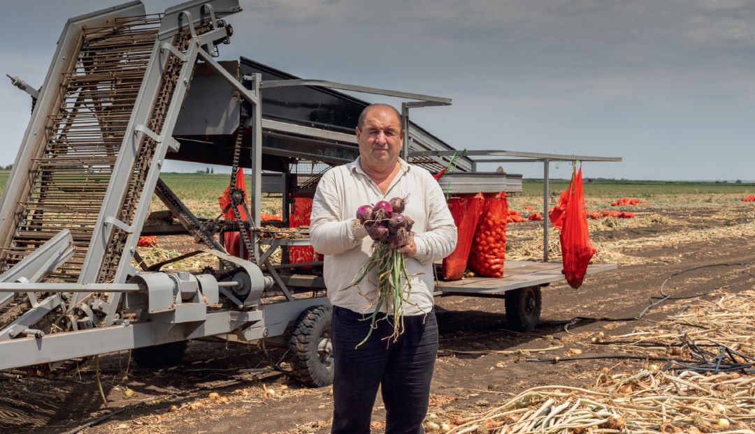 Махамат на фоне лукоуборочного комбайна